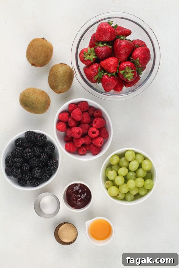 Fruit salsa ingredients arranged on a white countertop.