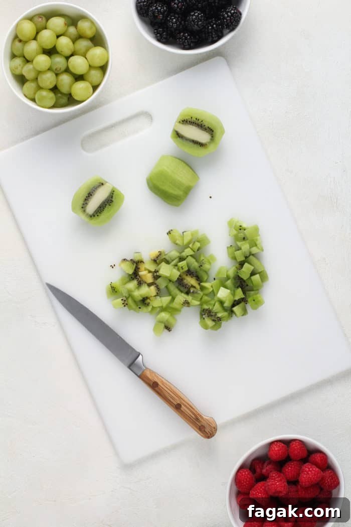 Diced kiwi on a white cutting board.