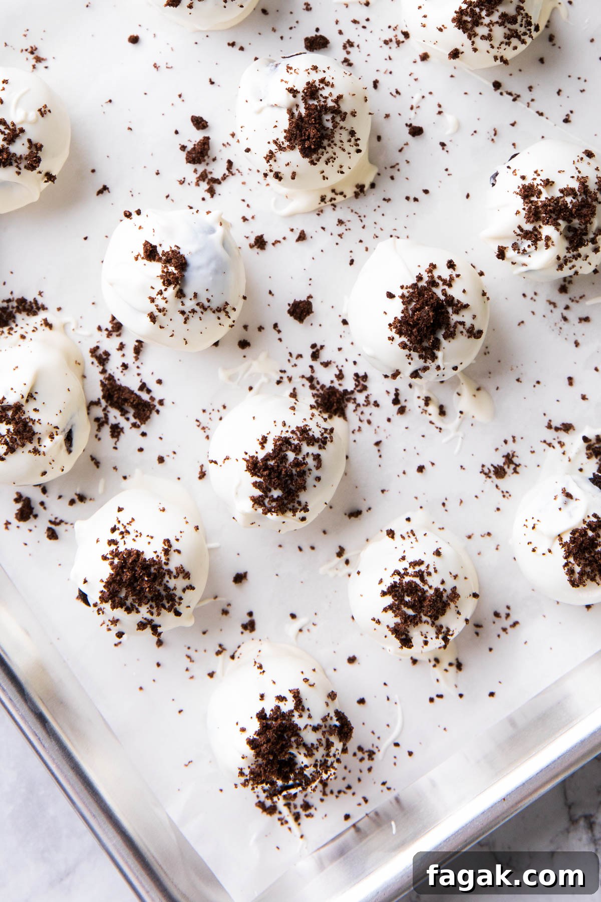 Oreo balls with cream cheese on a baking sheet, ready to be served for Christmas.