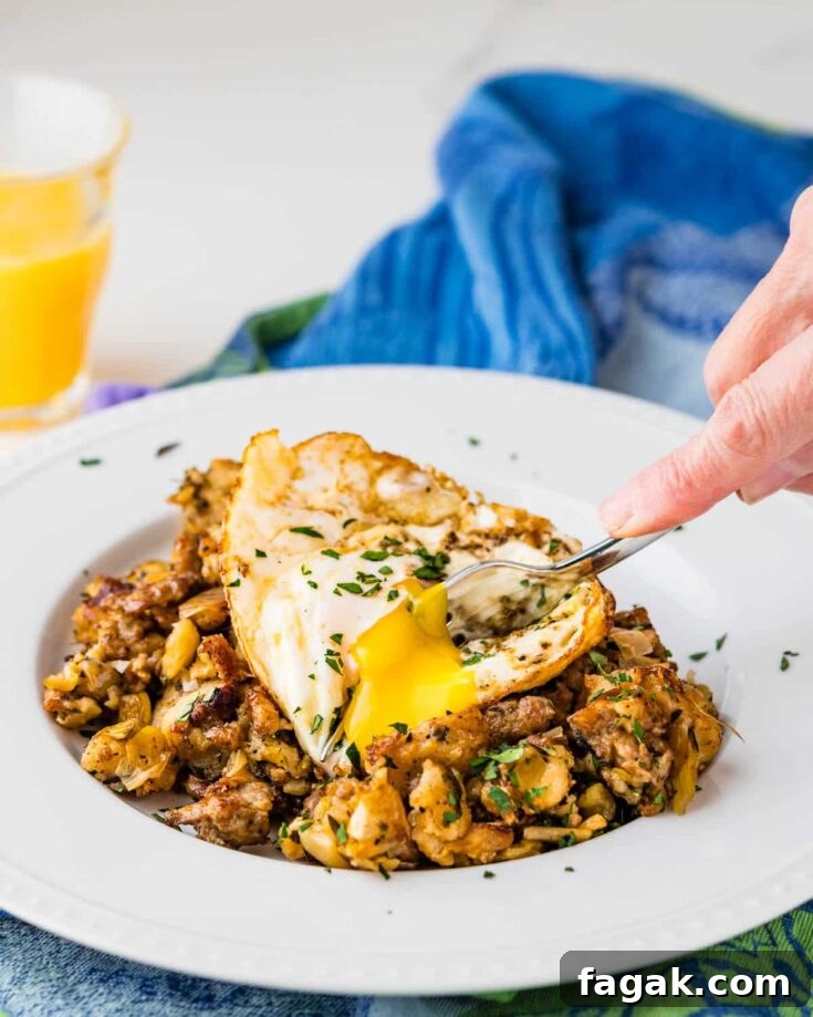 Hearty stuffing breakfast hash with a fried egg.