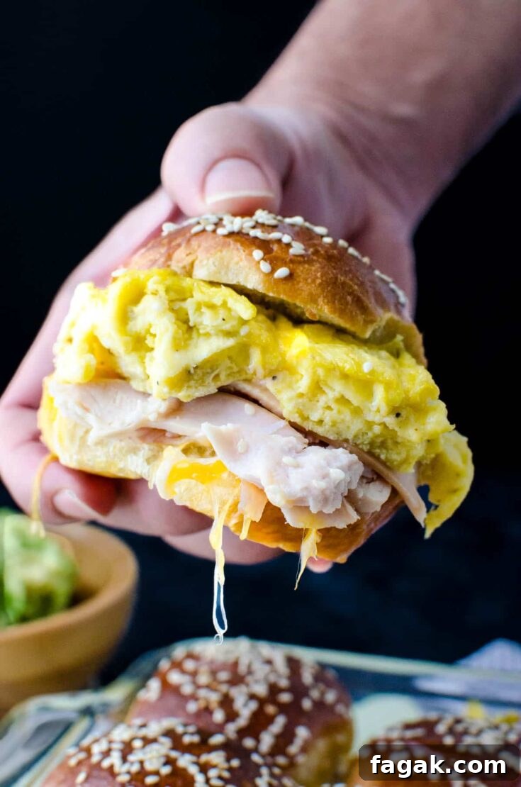 Holding a turkey and egg breakfast slider.