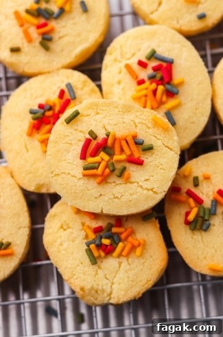 3 Ingredient Sugar Cookies on a cookie sheet grouped up with one prominently featured