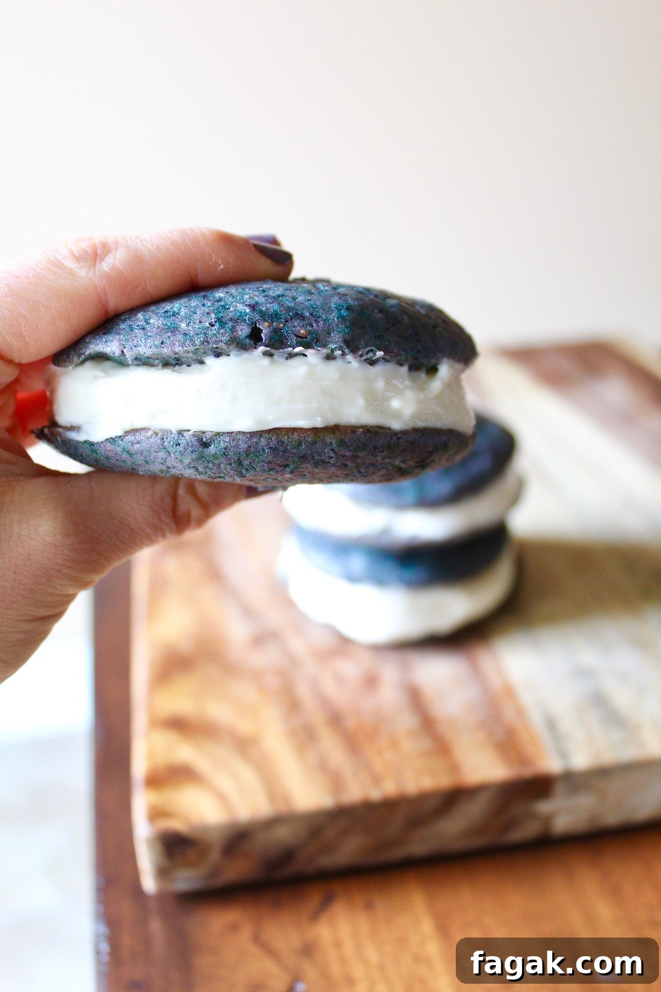 Hand grabbing wild blueberry whoopie pie