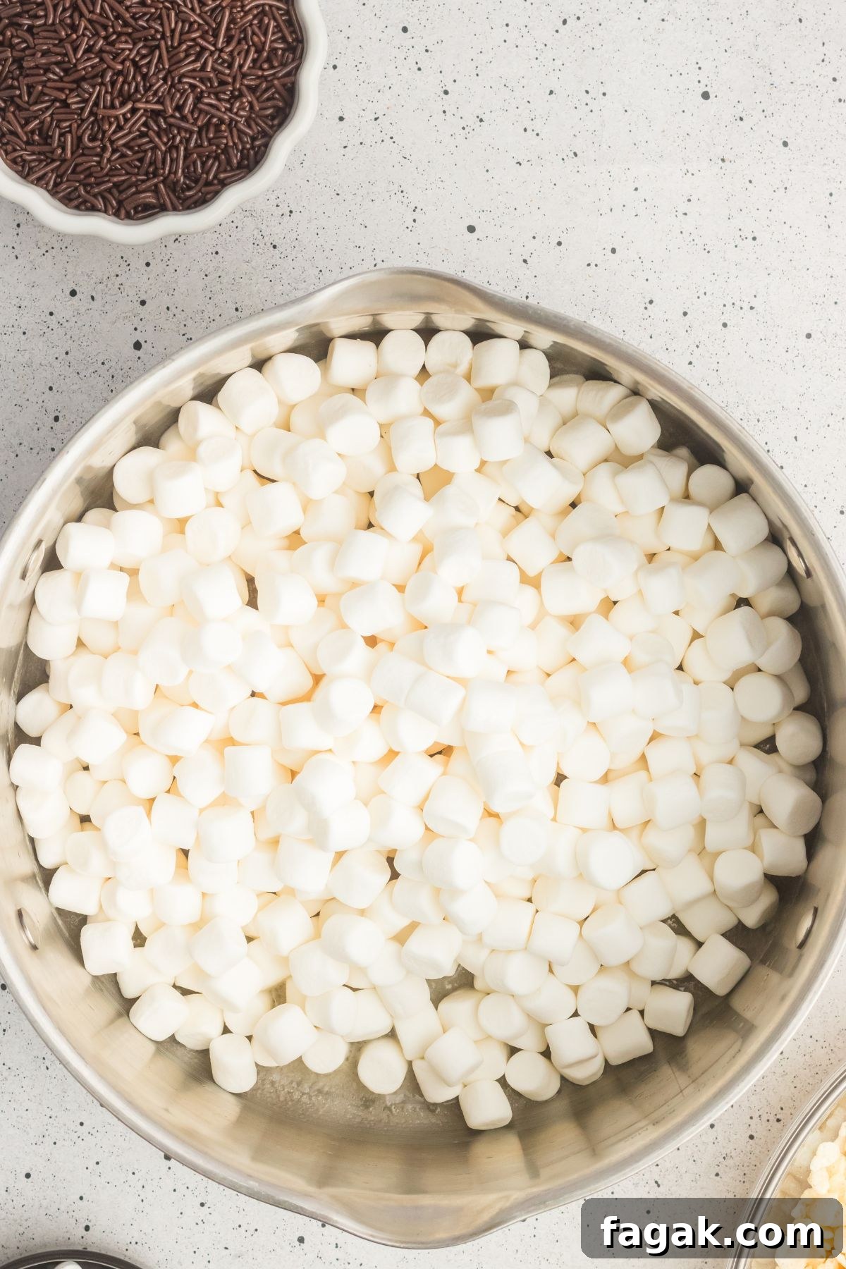 Marshmallows added to a large pot with melted butter.