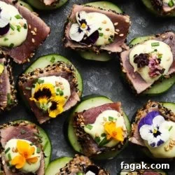 Seared ahi tuna cucumber bites topped with wasabi mayo and edible flowers.