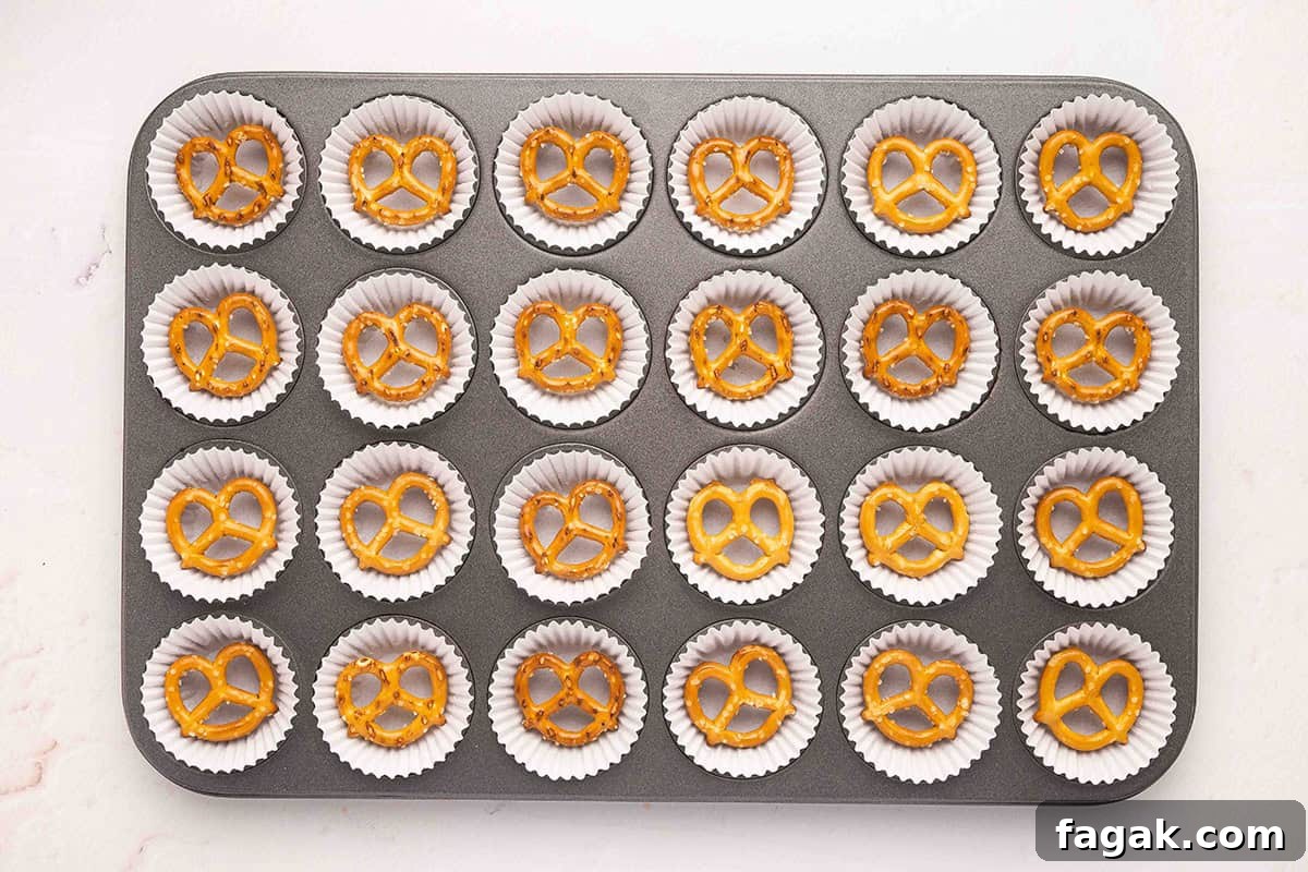 Pretzels in a mini muffin pan with muffin liners.
