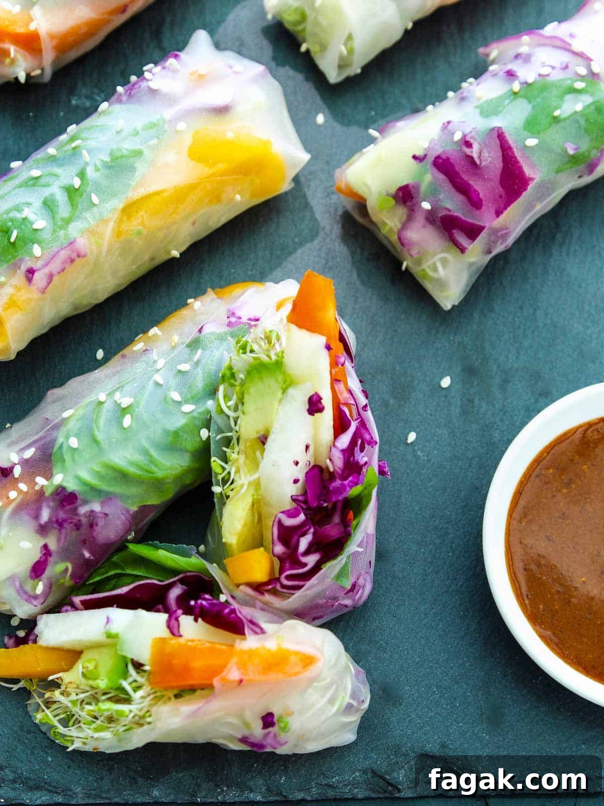 Crispy Vegetable Spring Rolls Recipe with Dipping Sauce 4 Spring rolls sliced open with ginger dipping sauce
