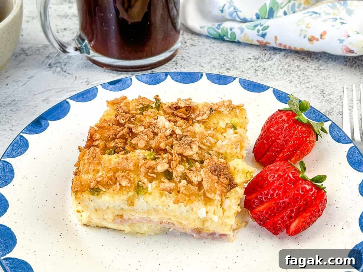 A closeup shot of breakfast casserole on a plate with berries.