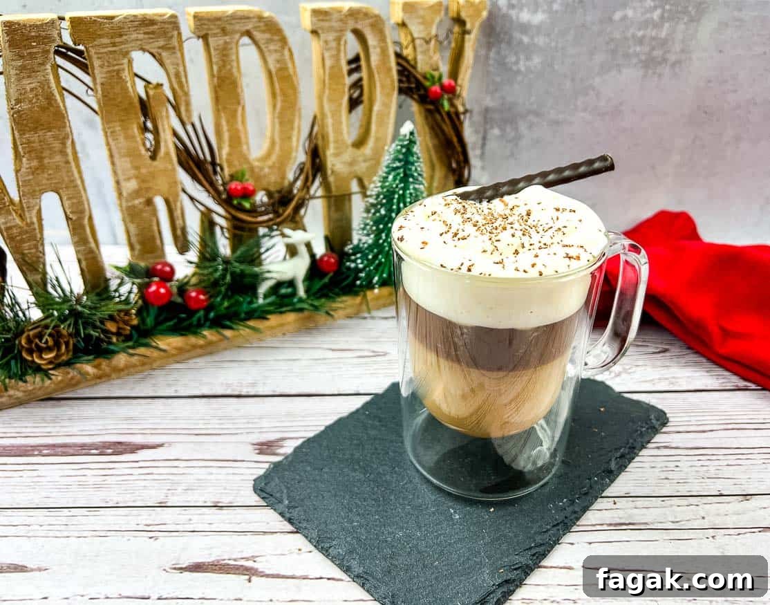 A canadian coffee with a whipped cream and cinnamon sticks.