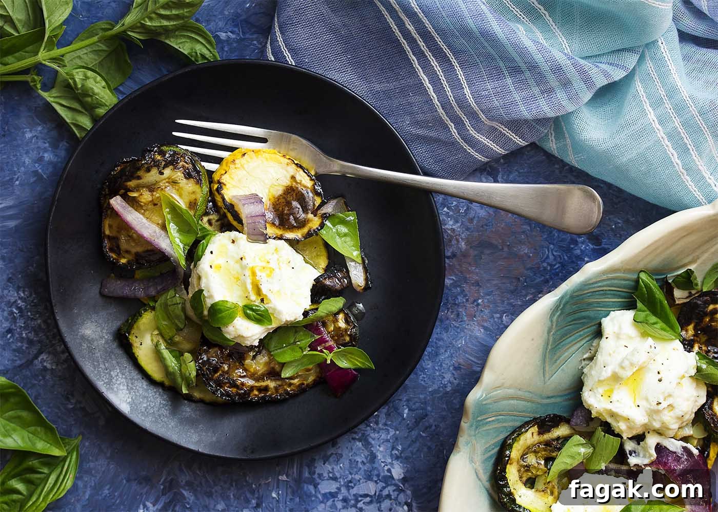 Top view of a black plate of grilled zucchini and lemon ricotta with a serving dish nearby.