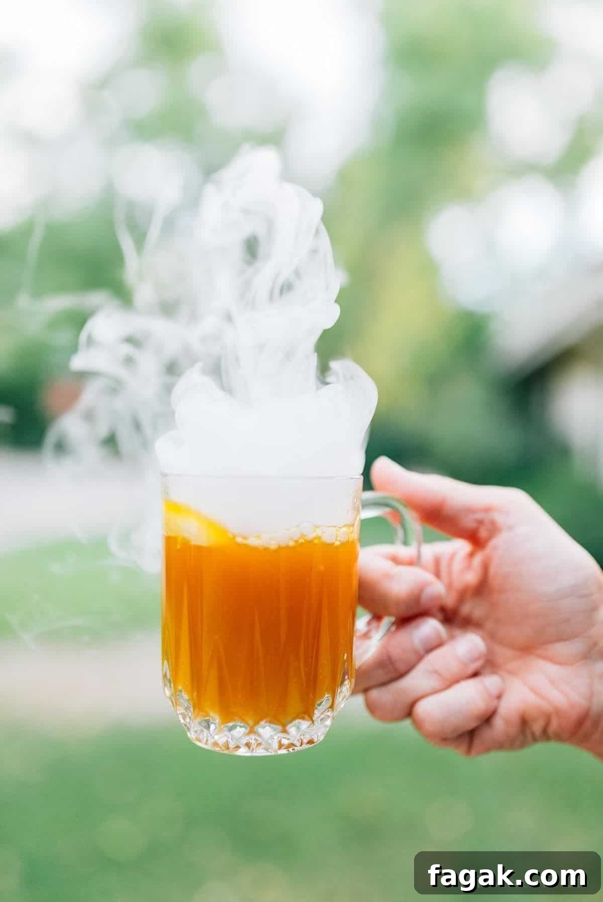 Pumpkin punch in a hand smoking