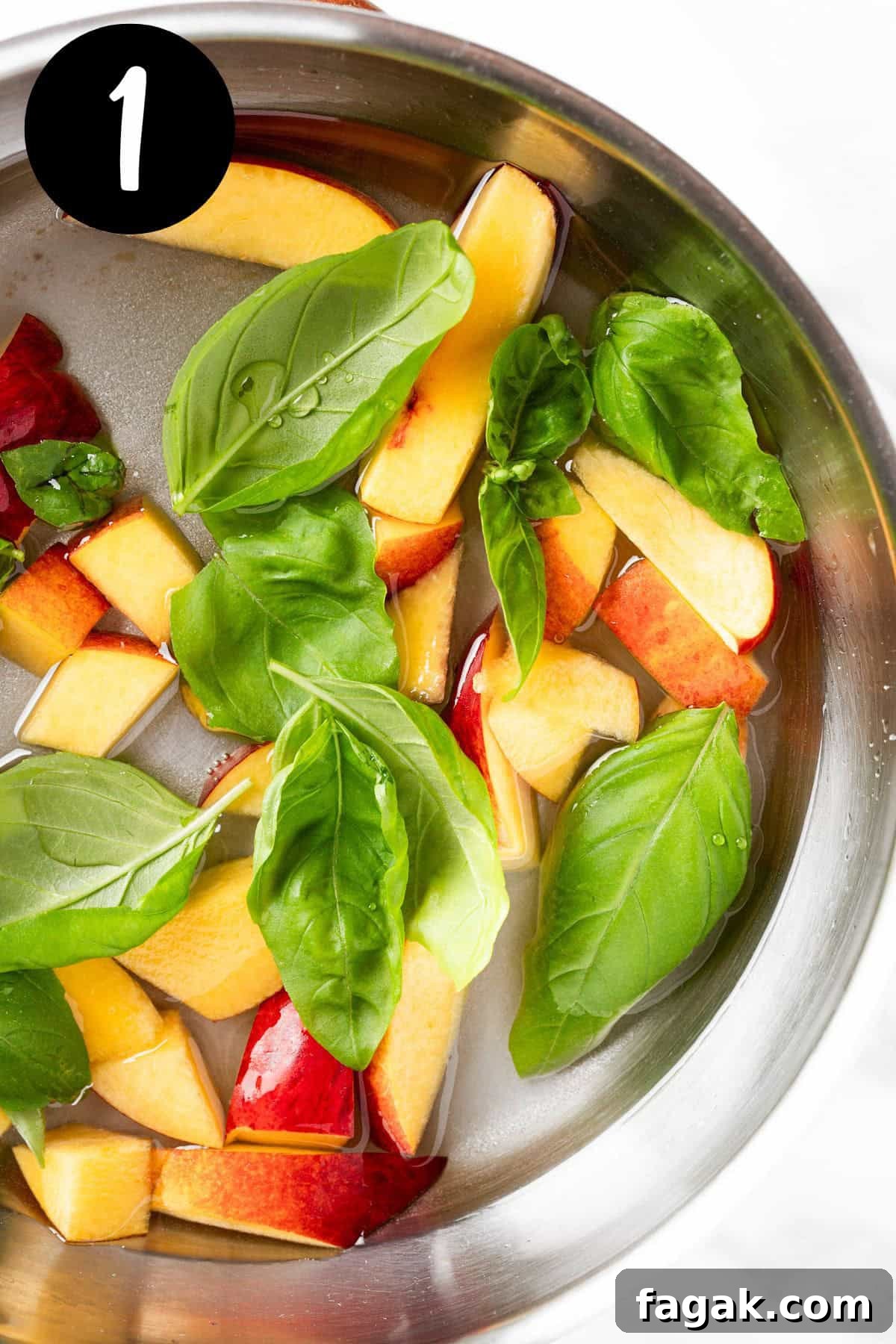 Heating the basil leaves, peach slices and syrup in a pan together.