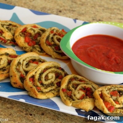 Party Pesto Pinwheels: Appetizer Recipe for Crowd-Friendly Parties 2 With just a few ingredients this Party Pesto Pinwheel recipe is easy to put together in a pinch - friends will love it! | OHMY-CREATIVE.COM