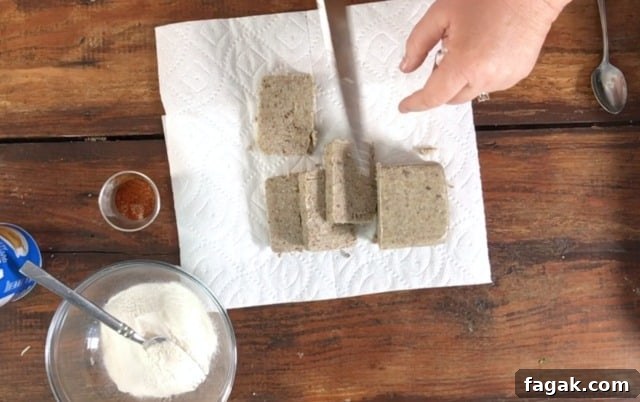 cutting the raw liver pudding into slices