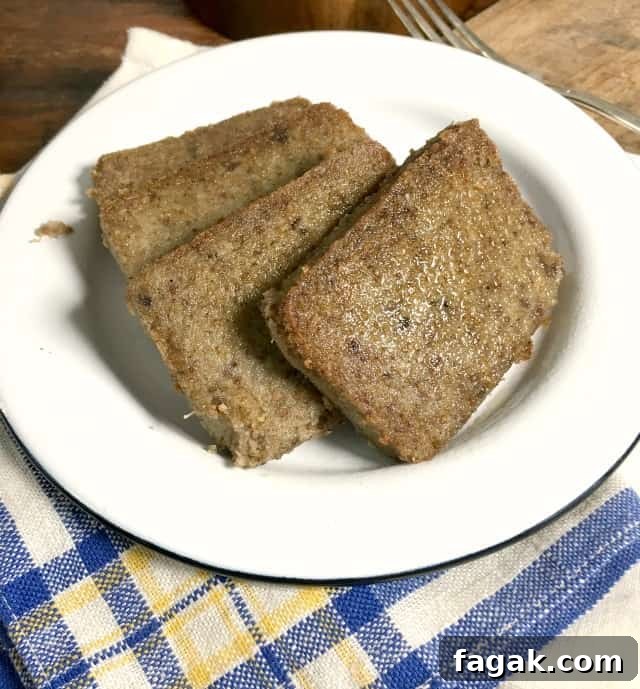 four slices of liver pudding on white plate with blue, white and yellow napkin