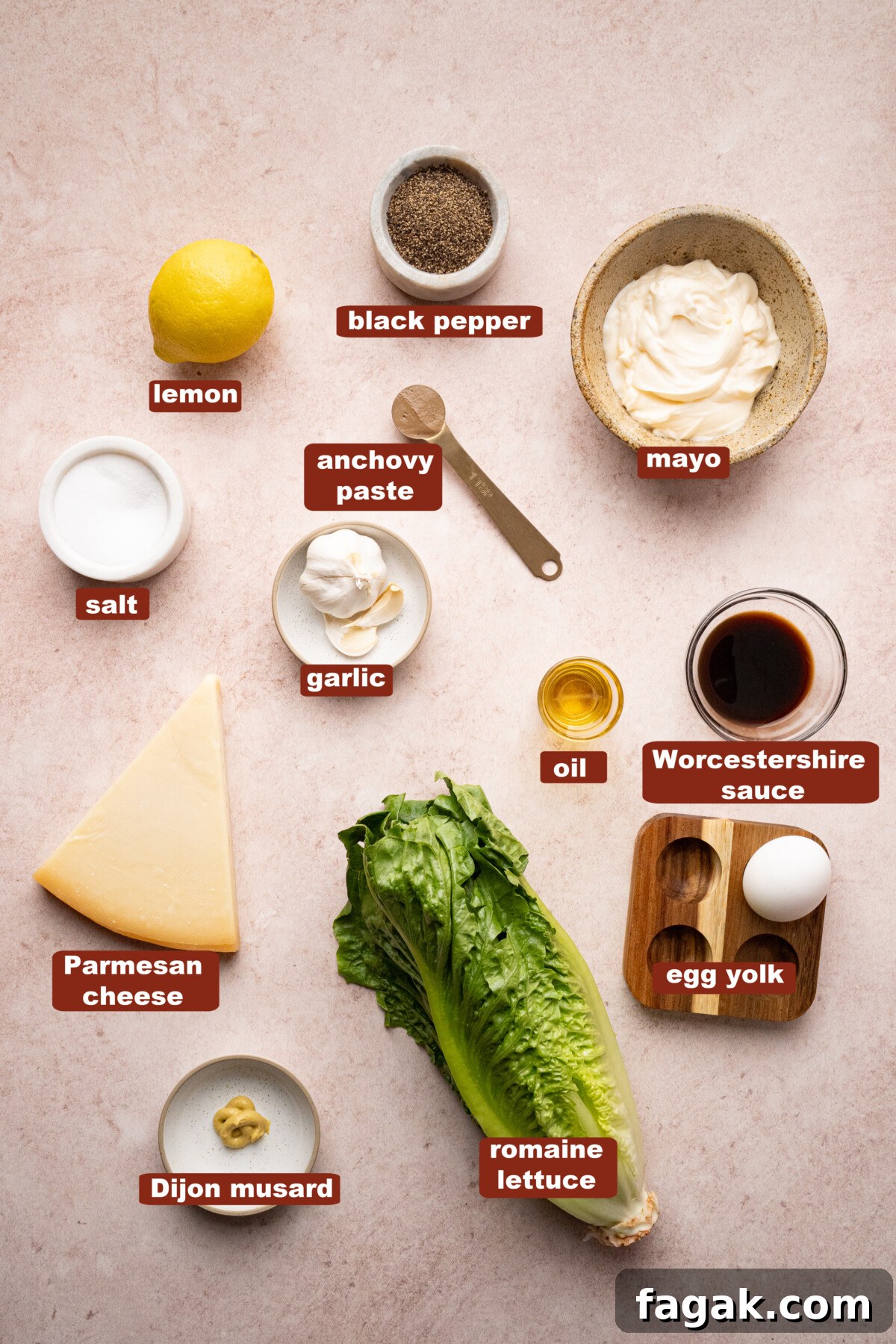 All of the ingredients for caesar salad in bowls on a countertop.