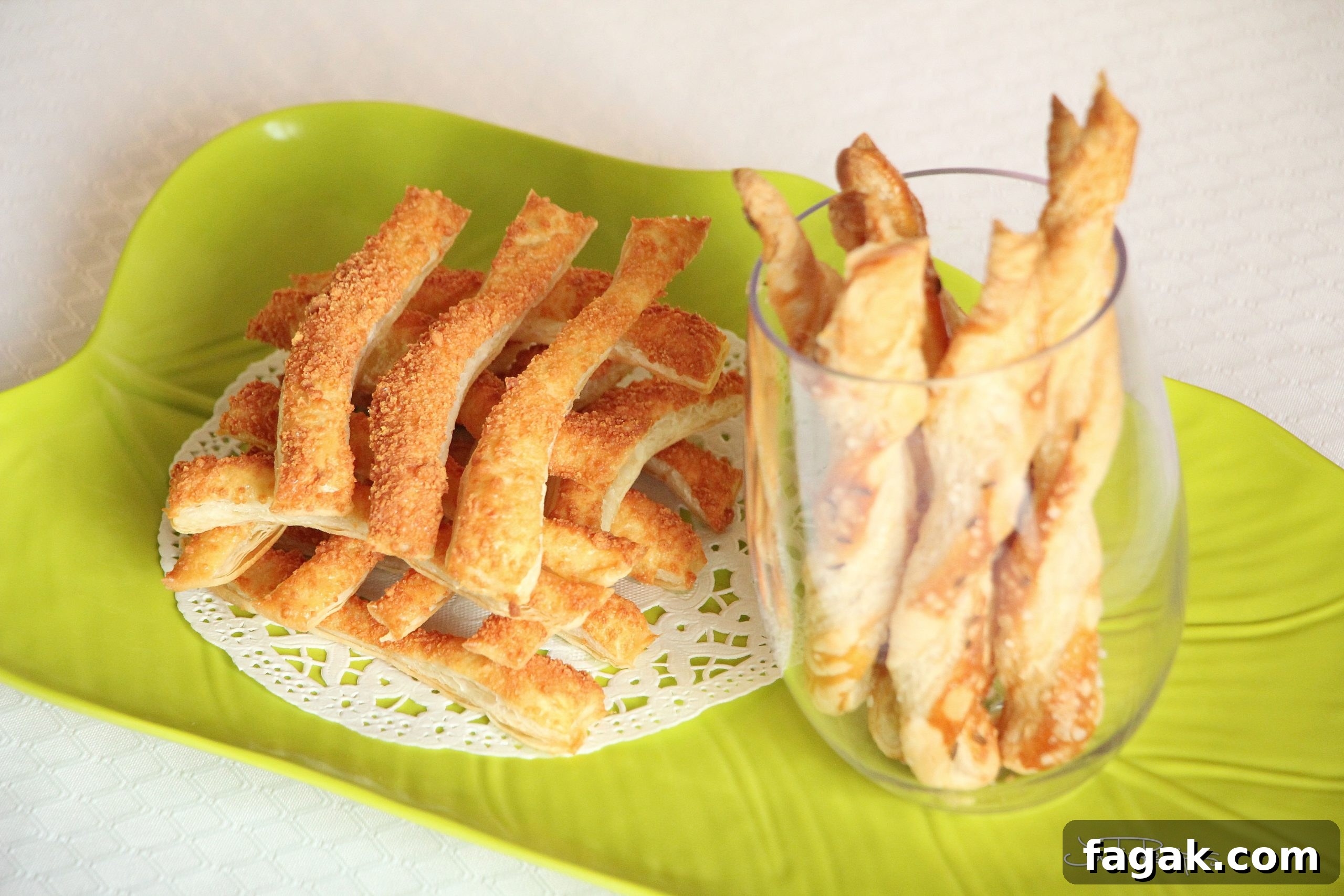 parmesan sticks on green plater and in wine glass