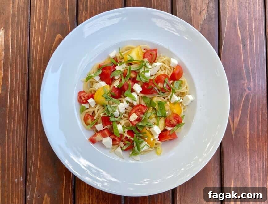 Fresh Tomato, Basil & Mozzarella Pasta Recipe for Summer 9 Served in a shallow bowl.