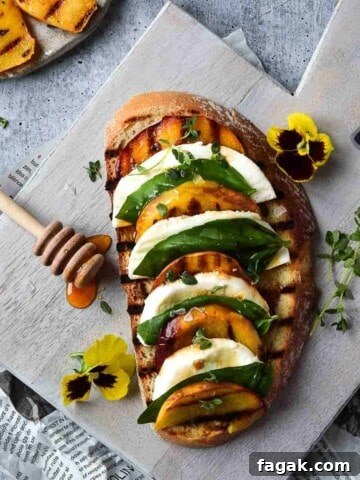 Overhead view of toast with grilled peaches layered with mozzarella, basil and balsamic.