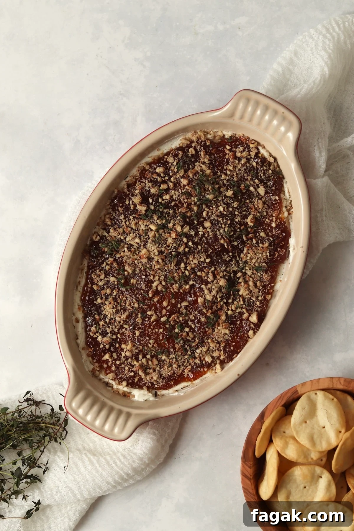 Goat Cheese and Fig Dip in a dish with pita chips and topped with thyme.