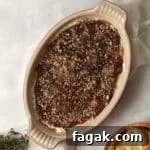 Goat Cheese and Fig Dip in a dish topped with thyme and pecans.