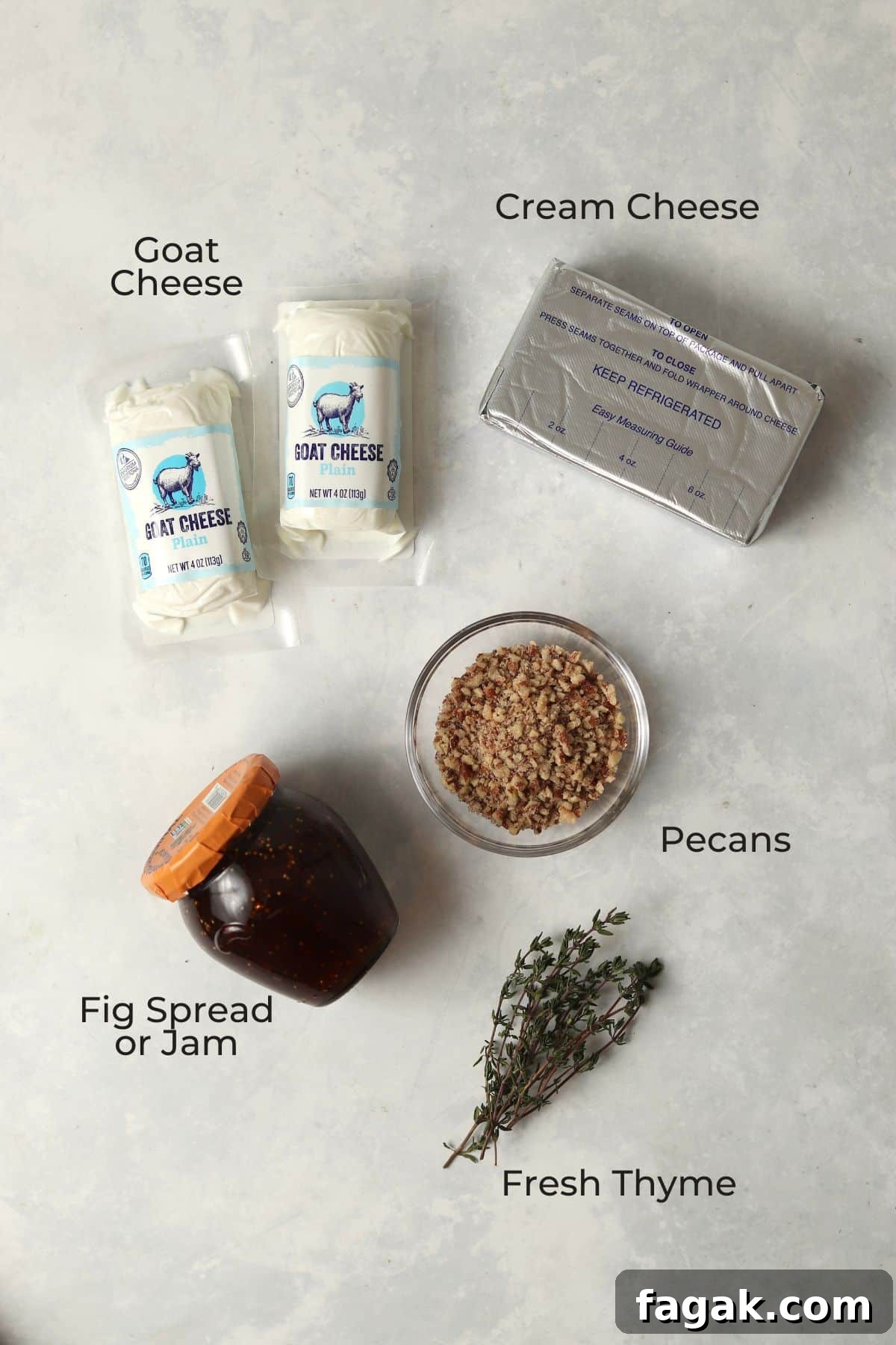 Cream cheese, goat cheese, fig spread, pecans, and thyme spread out as ingredients.