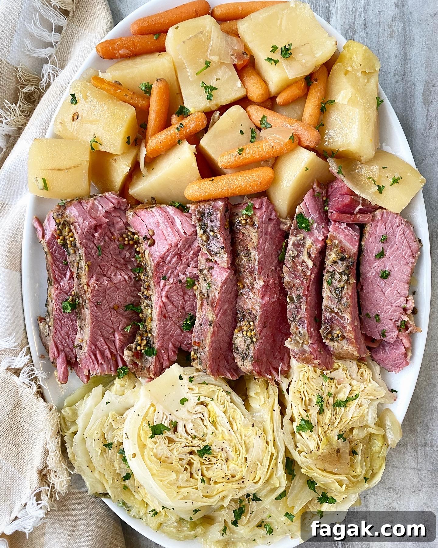 Slow Cooker Corned Beef and Cabbage Recipe (Video Included) 7 overhead shot of corned beef & cabbage with potatoes, carrots, and onion on a white platter