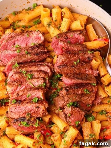 Cowboy butter steak rigatoni in a skillet.
