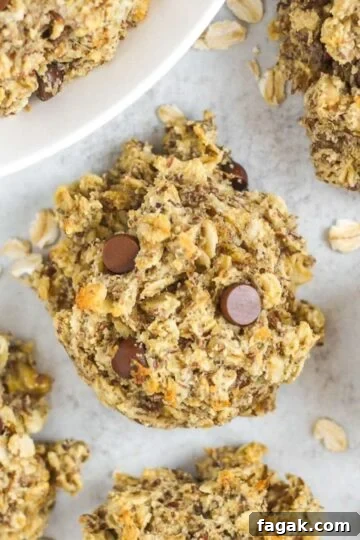 Breakfast oatmeal cookies with chocolate chips laid out on a gray surface.