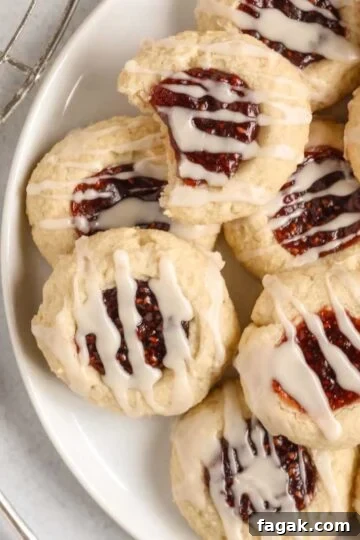 Gluten-free raspberry thumbprint cookies on a plate.