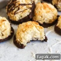 Coconut macaroon cookie with a bite taken out of it.