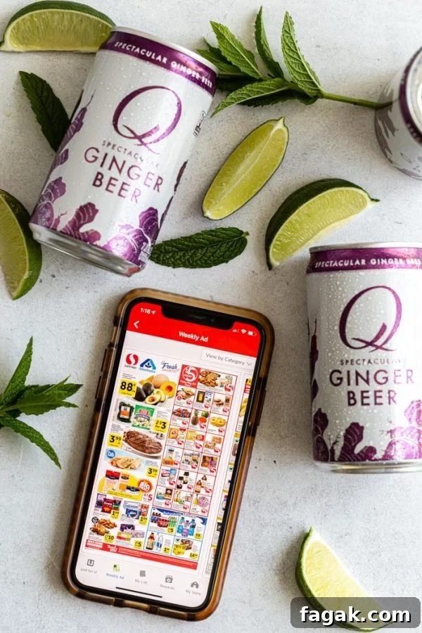 top down shot of an iphone with the safeway app showing on the screen. several cans of q gingerbeer around as well as lime wedges and mint sprigs
