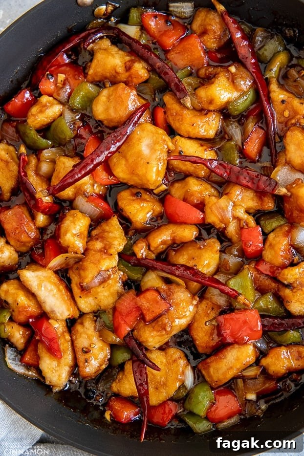 Chinese Szechuan Chicken Stir Fry in a black skillet 