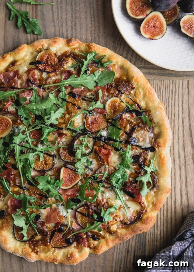 overhead of a baked fig pizza on a pizza peel