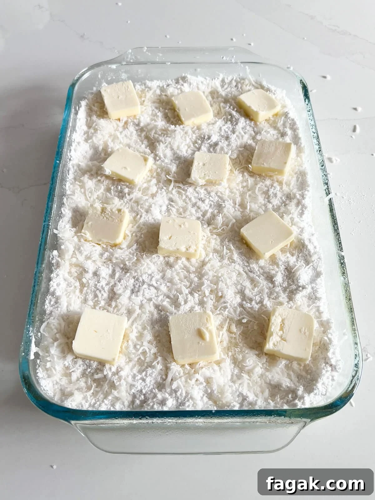 Pats of butter scattered across the top of the dump cake.
