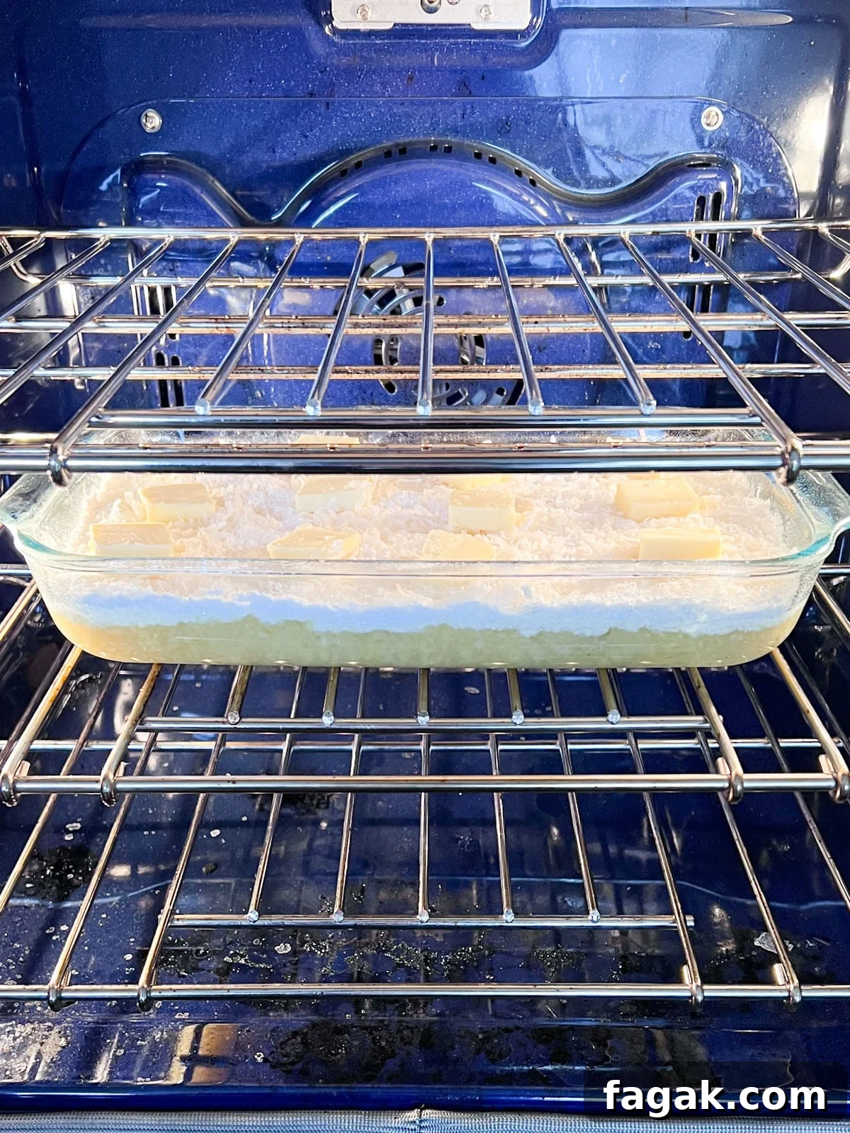 The pan of dump cake ingredients in the oven ready to bake.