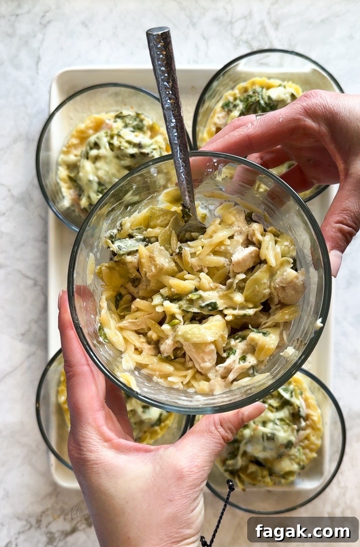 Spinach, Artichoke & Chicken Orzo Bake Recipe 2 Spinach Artichoke Chicken Orzo Bakes with visible chicken breast, orzo, spinach, artichoke hearts, and cheeses.