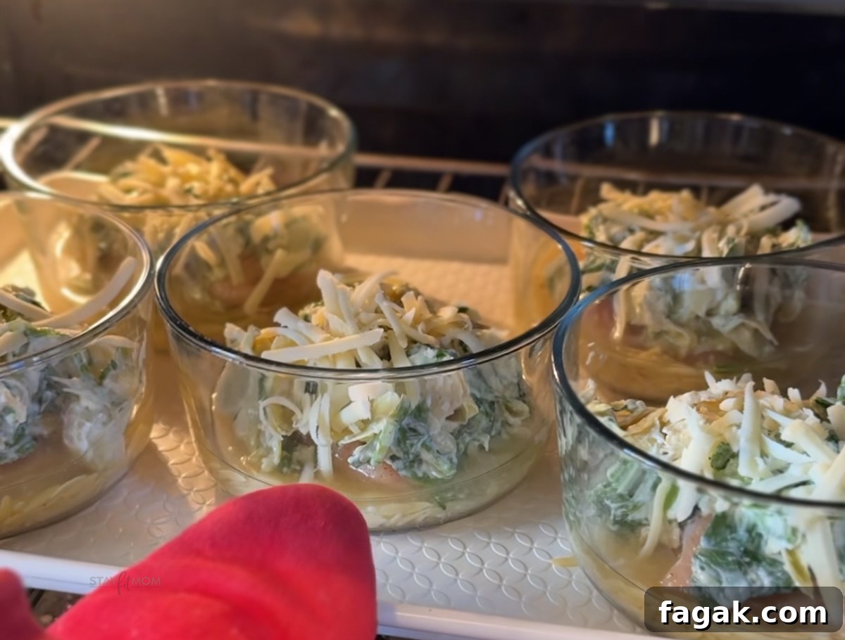 Spinach, Artichoke & Chicken Orzo Bake Recipe 5 Spinach Artichoke Chicken Orzo Bakes with visible chicken breast, orzo, spinach, artichoke hearts, and cheeses.