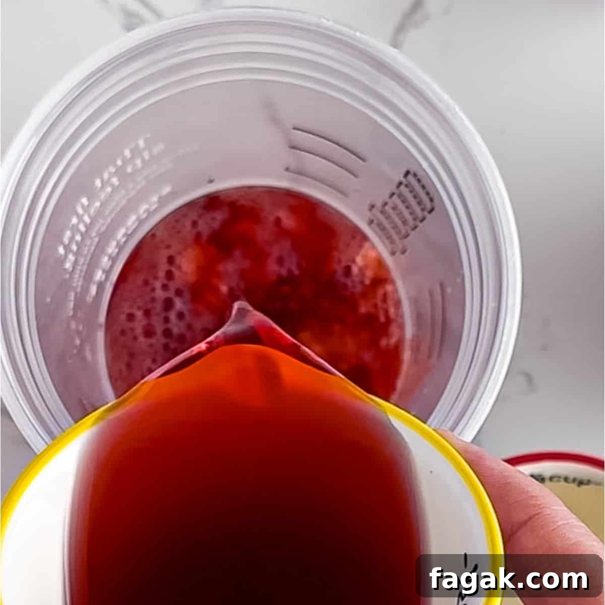 Adding tea to the bottom of a glass.