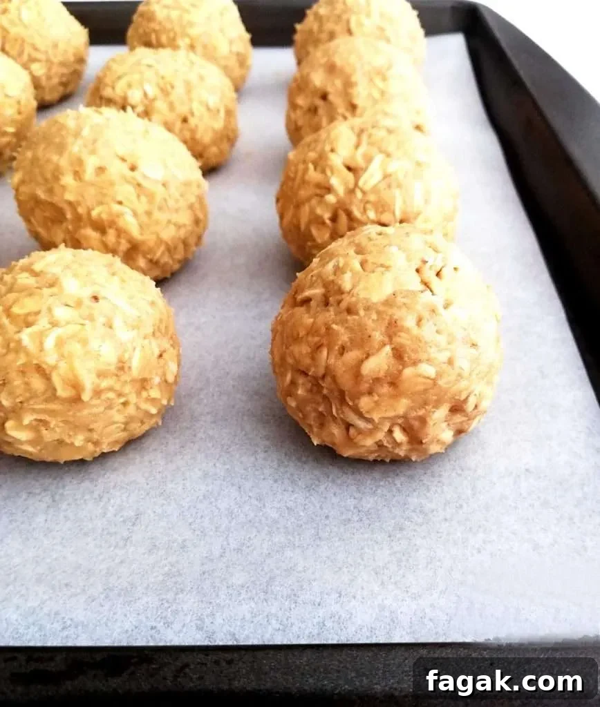 oatmeal cookie dough balls on baking sheet side view