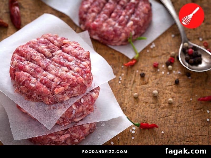 White stuff on burger patties may be due to fat and other beef parts, freezer burn or may be due to food spoilage.