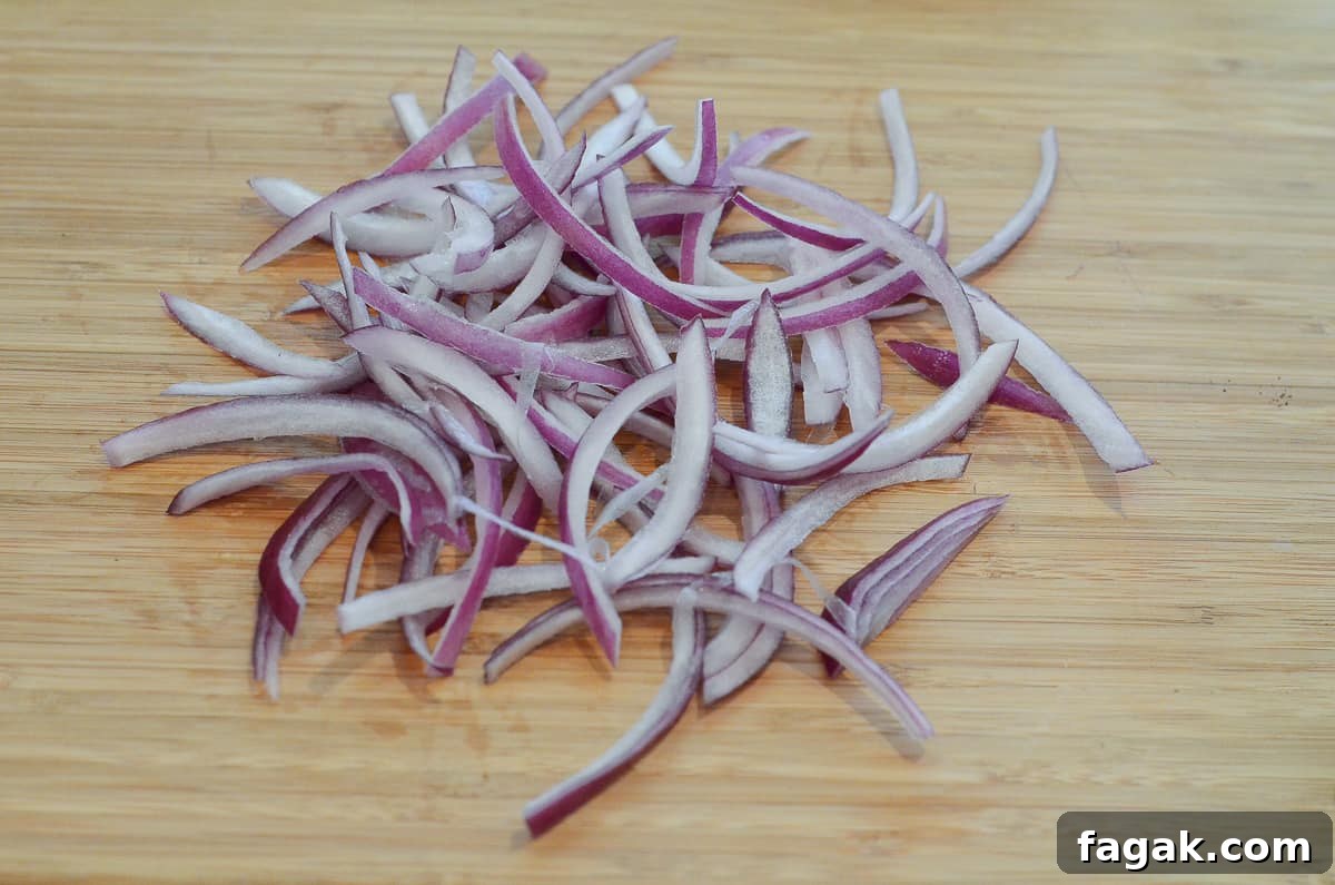 Sliced red onion on a cutting board.