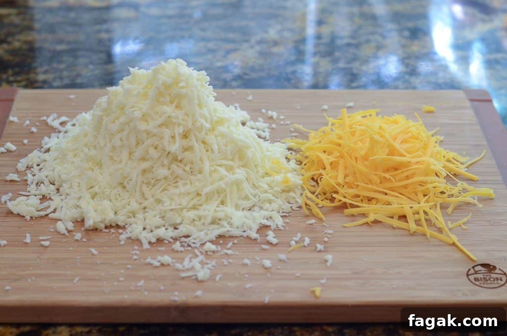 Shredded cheese on a cutting board.