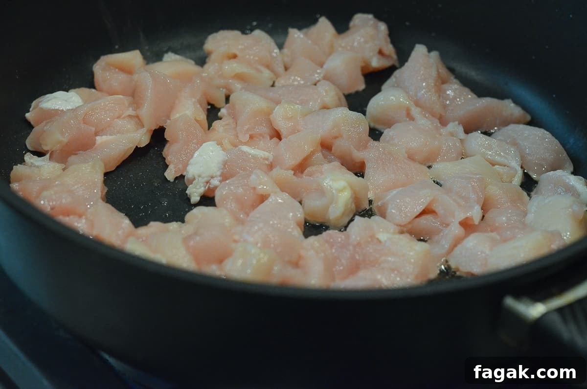Chicken cooking in a skillet.
