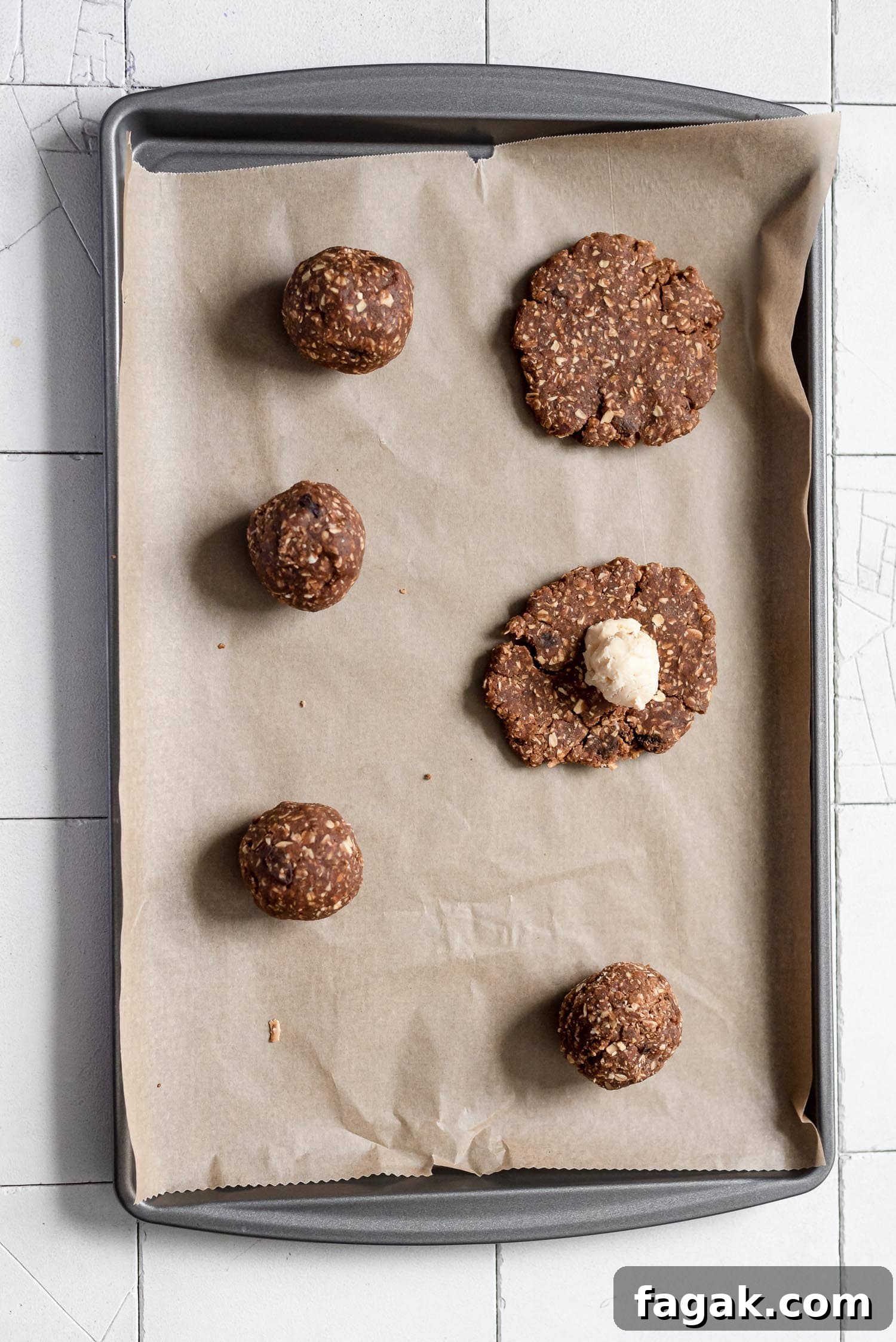 cookies being roled and places on baking sheet