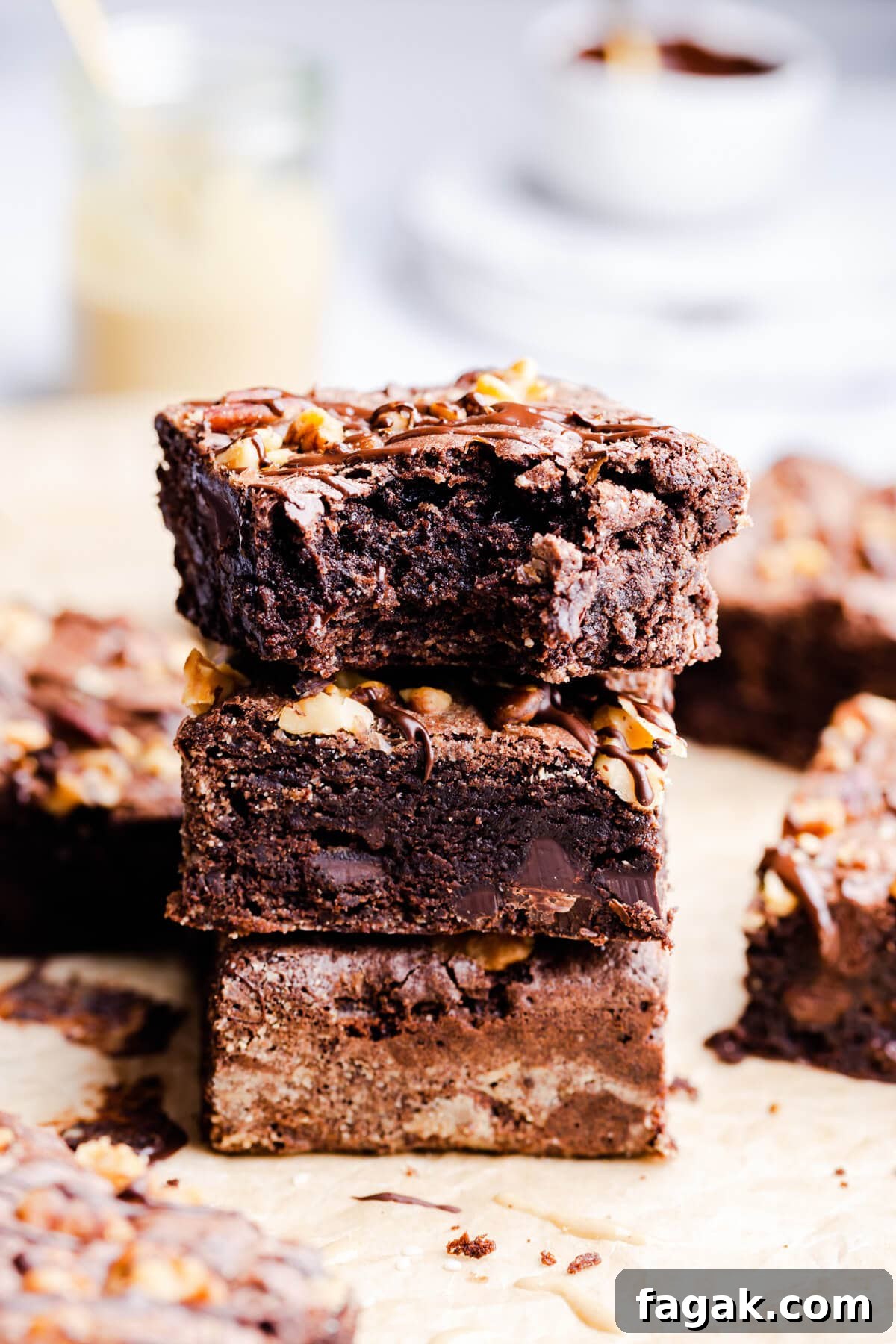 side view of three tahini brownies in a stack with the top one missing a bite