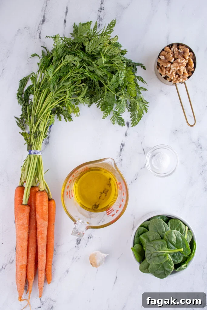 The ingredients needed to make carrot top pesto laid out on a tabletop.