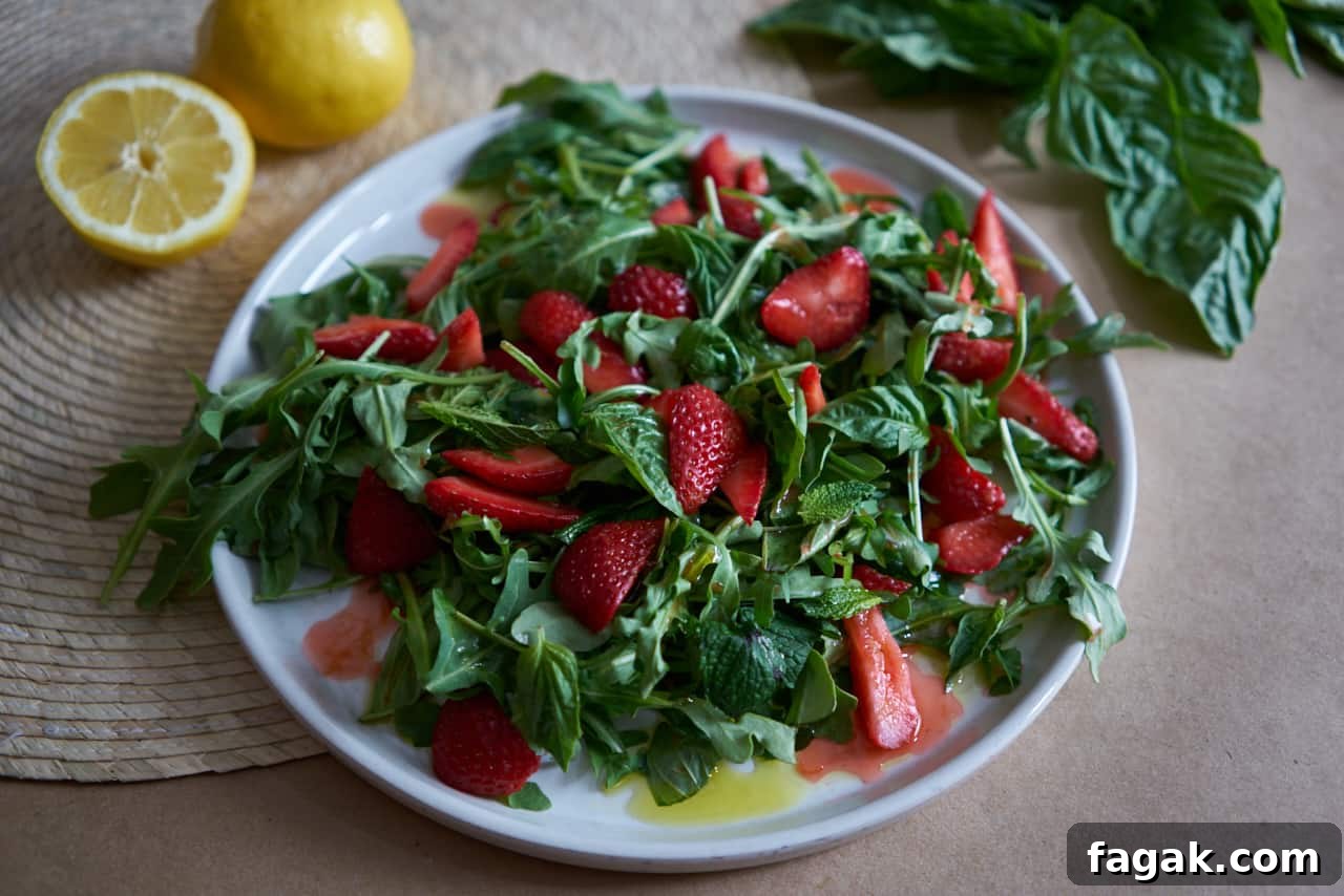 Strawberry arugula salad with herbs.