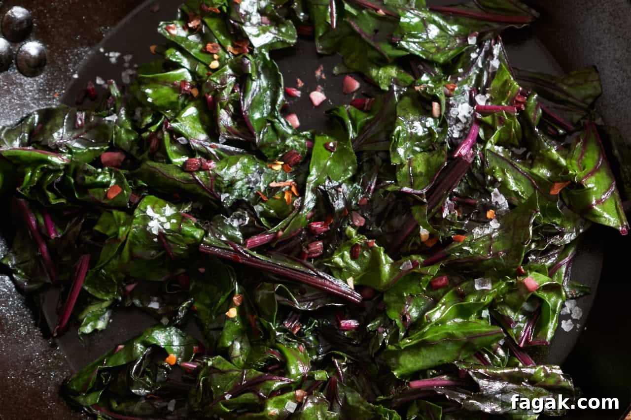 Sautéed beet greens in a cast iron skillet.