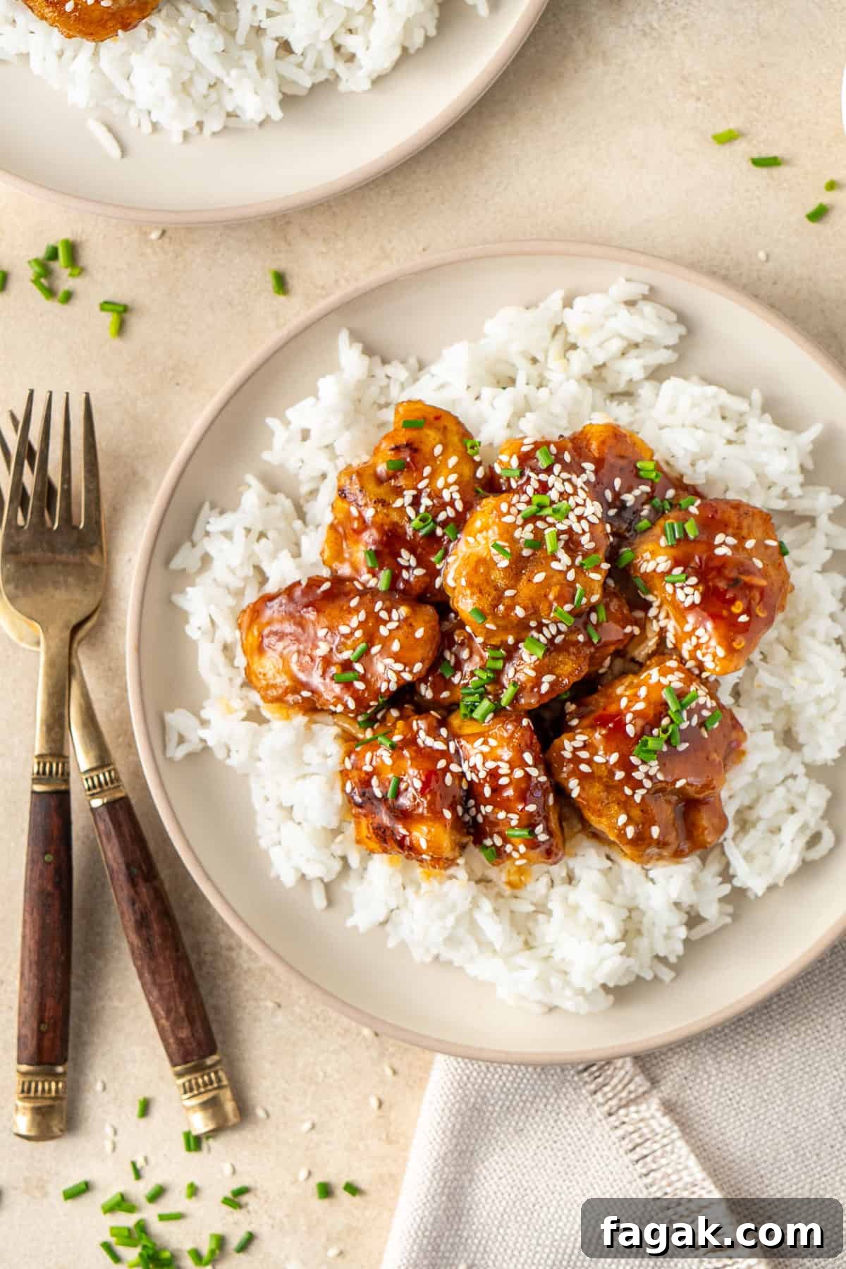 Close up of sweet chilli chicken on a plate served with rice.